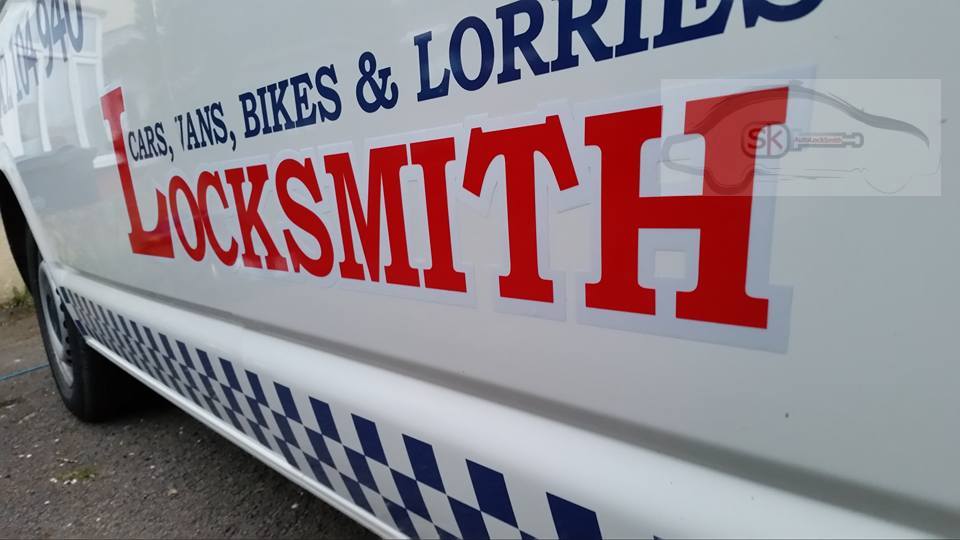 Close up photo of the livery on the side of an SK AutoLocksmith mobile service van